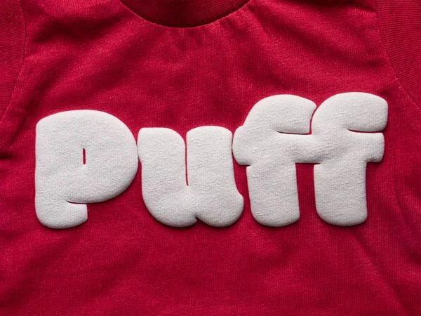 Raised white puff lettering on a red T-shirt