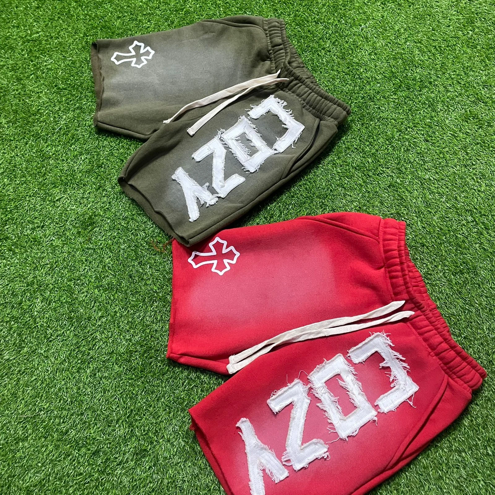 Custom shorts with decorative patch and distressed graphic details