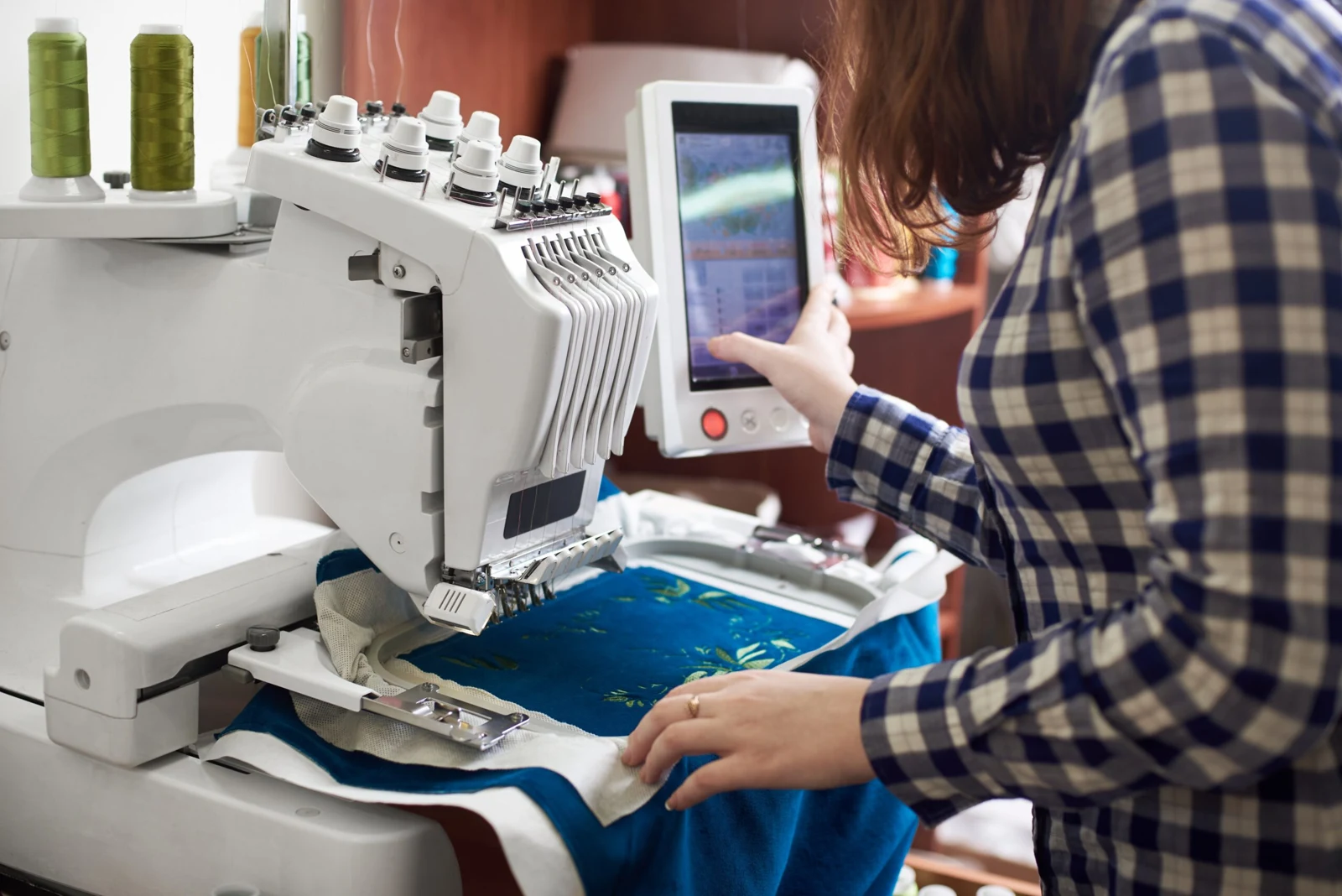 Embroidery machine stitching a design onto a garment