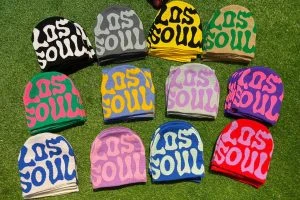 Colourful knitted beanies with contrasting patterned lettering