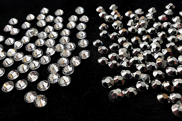 Crystal and metallic rhinestones arranged on a dark background